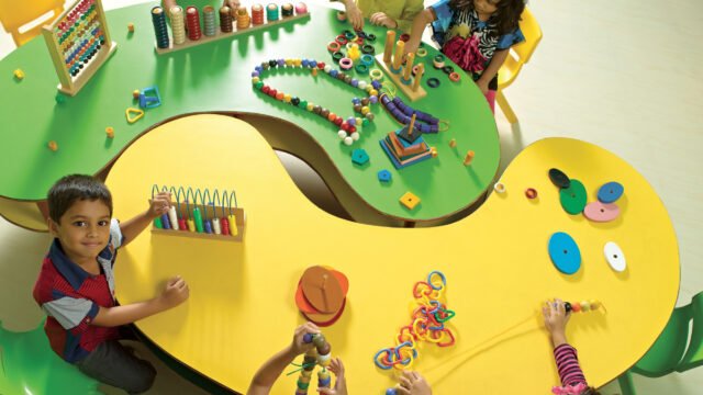 A vibrant classroom at The Creek SEEDS School filled with children engaging in creative learning activities, showcasing a nurturing environment for early education.